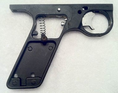 Set screws in pot metal autococker frame.