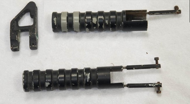 Two pump handles from the PSI M-16 Stinger and a front sight.