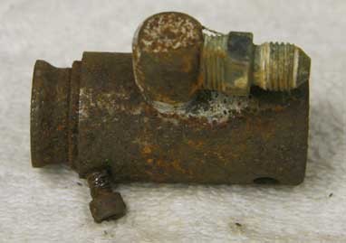 Left side view of a stock 007 nelspot in grip valve that has had the piercer hole plugged and a side tap added.