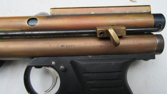 Close up of left side view, showing thumb stop and feed port.