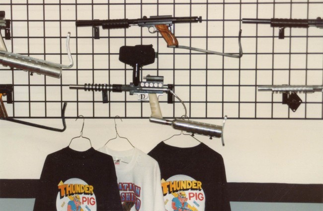 Thunder Pig T-Shirts on the wall under a nelson framed Carter Comp and a "Rolling Thunder" engraved Buzzard that likely belongs to Fernando Castillo. Photo from the archives of Ted Hines.