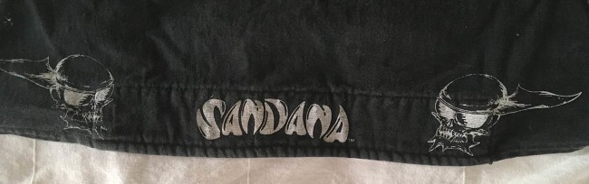 Sandana silk screen on the hear wrap with fly skulls beside it.