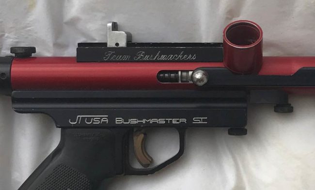 Close up of right side of JT USA Bushmaster with Bushwacker engraving on sight rail.