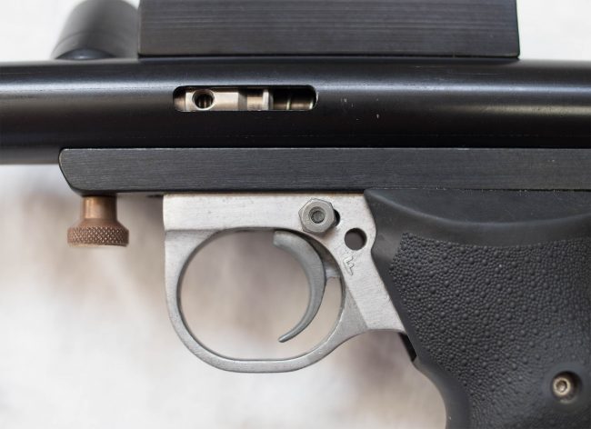 Left side of pinned trigger slide to swing frame.