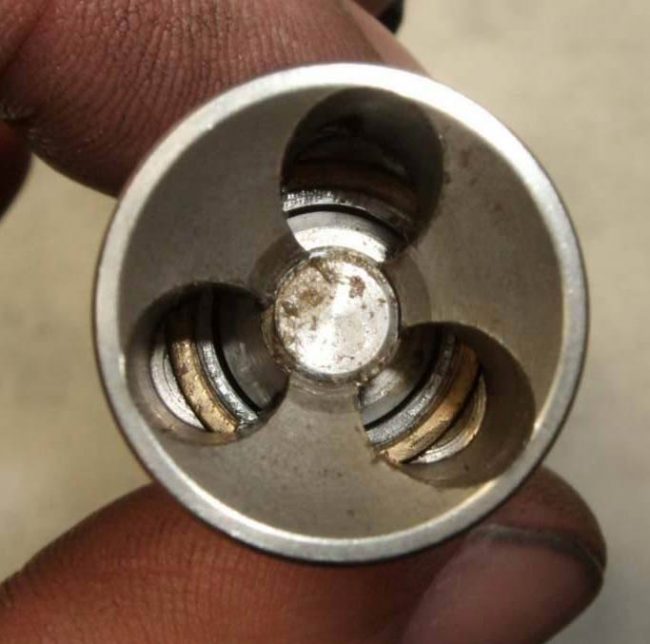 Bolt face. Center piece needs to come out to allow bolt to be removed from hammer assembly. Photo courtesy Paul Cross.