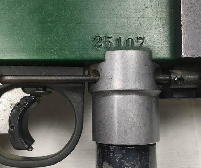 Serial number 25107 on the side of this green engraved Autococker.